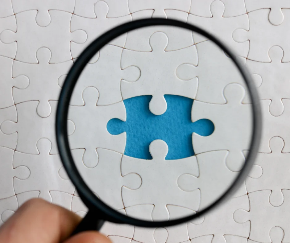 Someone observing a puzzle with magnifying glass