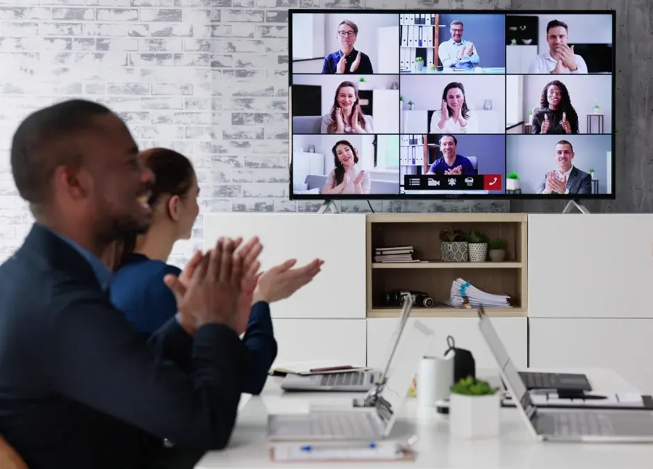 Employees partaking in virtual team building activities in conference room
